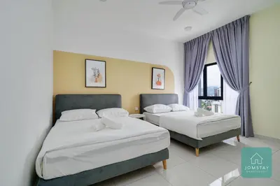 a bedroom with two beds and a window at JOMSTAY - Horizon Suites Ipoh Town Skypool in Ipoh