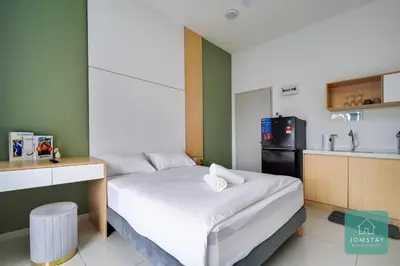 a small room with a bed and a kitchen at JOMSTAY - Horizon Suites Ipoh Town Skypool in Ipoh