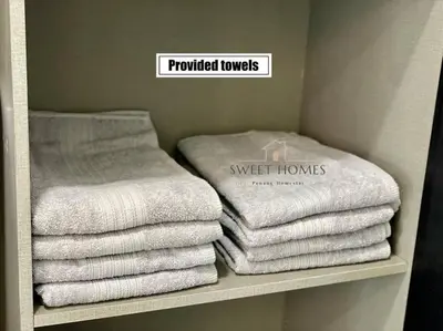 a pile of towels on a shelf in a bathroom at Catty Suite Prai • 3BR • 2Carparks@6mins PG Bridge in Perai