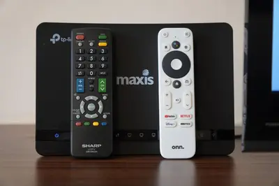 two remote controls are sitting next to each other at Taiping Modern Home in Kamunting