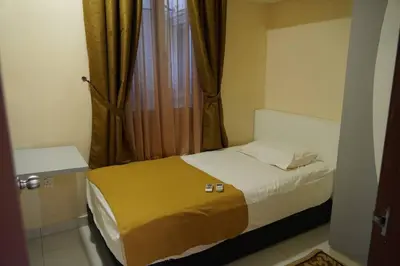 a small bedroom with a bed and a window at Taiping Modern Home in Kamunting