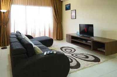a living room with a couch and a tv at Taiping Modern Home in Kamunting