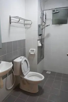 a bathroom with a toilet and a sink at Taiping Modern Home in Kamunting