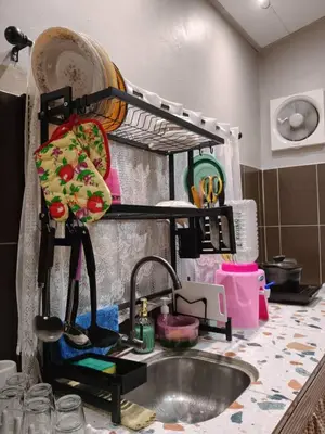 a kitchen counter with a sink and a shelf at Kampung Cottage Bagan Datuk in Selekoh
