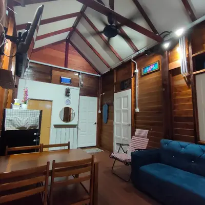a living room with a couch and a table at Kampung Cottage Bagan Datuk in Selekoh