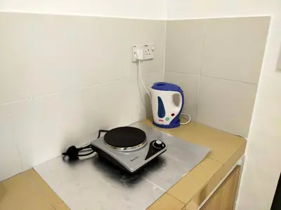a toaster sitting on a counter in a kitchen at Homestay Manitha in Seri Manjung