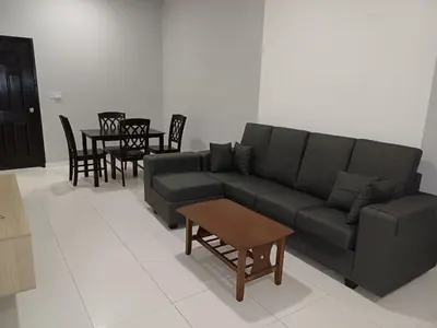 a living room with a couch and a table at Homestay Manitha in Seri Manjung