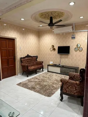 a living room with furniture and a ceiling fan at Thumbs Up HomeStay in Kampong Jalan Berop