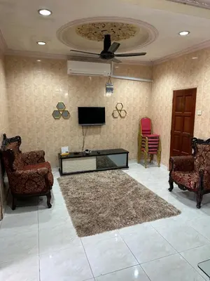 a living room with two chairs and a flat screen tv at Thumbs Up HomeStay in Kampong Jalan Berop