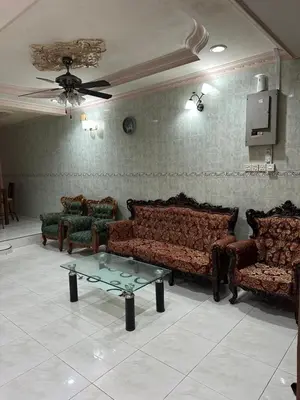 a living room with couches and a table and a tv at Thumbs Up HomeStay in Kampong Jalan Berop