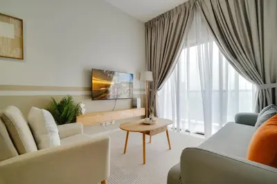 a living room with a couch and a tv at The Horizon Ipoh By Iconique Espace in Ipoh