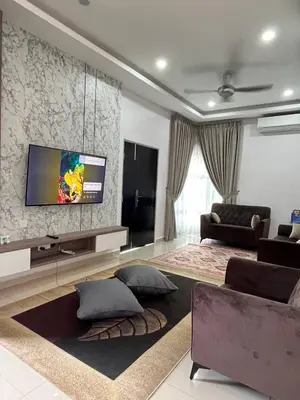a living room with a flat screen tv on a wall at Tambun Hillview Cottage 2 in Ipoh