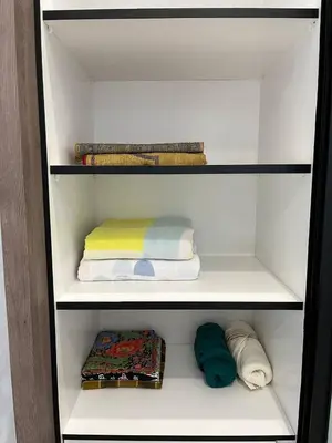 a walk in closet with towels and towels at Tambun Hillview Cottage 2 in Ipoh