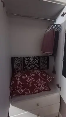a bedroom with a bed and pillows on a shelf at Homestay Rezeki Batu Gajah in Batu Gajah
