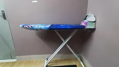 a blue pillow on a stand next to a wall at Homestay Rezeki Batu Gajah in Batu Gajah