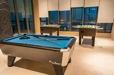 a pool table in a room with pool sticks on it at Ipoh Tambun Lost World Sunway Onsen Mina 3R2B 8pax in Tambun