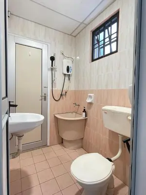 a bathroom with a toilet and a sink and a bath tub at Unique 4 Bedrooms House, Few mins to Town by Mr Homestay in Teluk Intan