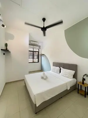a bedroom with a bed with a ceiling fan at Unique 4 Bedrooms House, Few mins to Town by Mr Homestay in Teluk Intan