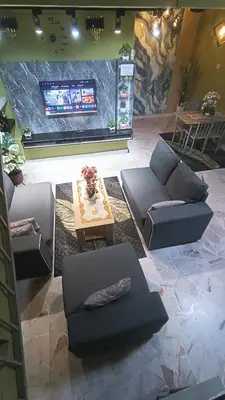 a living room with couches and a flat screen tv at HOMESTAY Rezeki in Batu Gajah