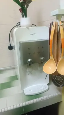 a sewing machine on a shelf with wooden spoons at HOMESTAY Rezeki in Batu Gajah
