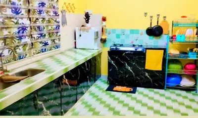 a kitchen with a counter with a sink and a refrigerator at HOMESTAY Rezeki in Batu Gajah