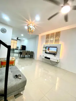a living room with a tv on a wall at LH SUITE HOMESTAY Gua Musang- Masjid Mekah in Gua Musang
