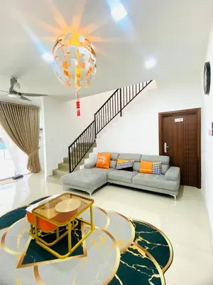 a living room with a couch and a table at LH SUITE HOMESTAY Gua Musang- Masjid Mekah in Gua Musang