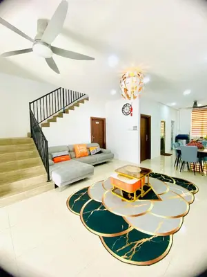 a living room with a ceiling fan and a couch at LH SUITE HOMESTAY Gua Musang- Masjid Mekah in Gua Musang