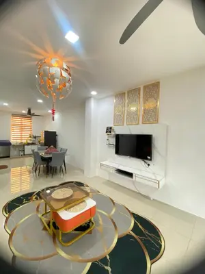 a living room with a table and a tv at LH SUITE HOMESTAY Gua Musang- Masjid Mekah in Gua Musang