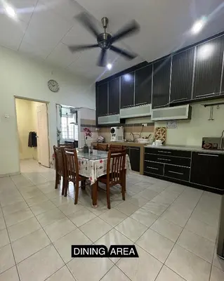 a kitchen with a table and chairs and a ceiling fan at Tamu House Botani in Ipoh