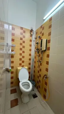 a bathroom with a shower with a toilet in it at Tamu House Botani in Ipoh