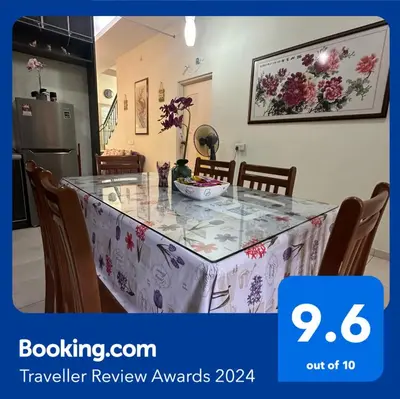 a dining room table with a table cloth on it at Tamu House Botani in Ipoh