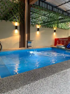 a pool with a water fountain in a building at Impiana Pool House Seri Manjung in Seri Manjung