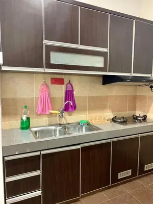a kitchen with a sink and a stove at Impiana Pool House Seri Manjung in Seri Manjung