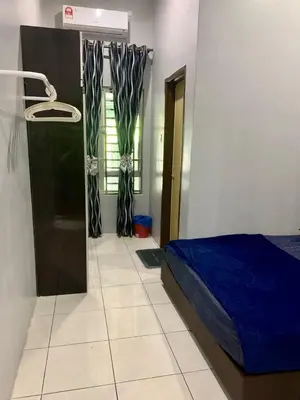 a bedroom with a blue bed and a window at Impiana Pool House Seri Manjung in Seri Manjung