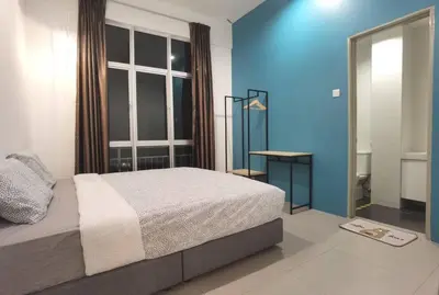 a bedroom with a bed and a blue wall at G Residence - 2R2B Barrington Night Market (1) in Brinchang
