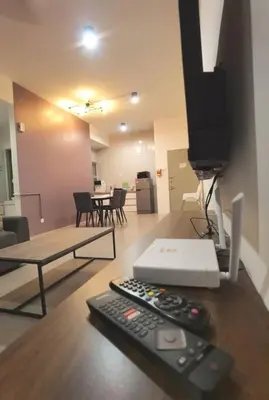 a remote control sitting on a table in a living room at G Residence - 2R2B Barrington Night Market (1) in Brinchang