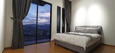 a bedroom with a bed and a large window at Beacon Executive Suites George Town Apartment Malaysia deals in George Town