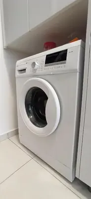 a white washing machine sitting in a kitchen at Beacon Executive Suites George Town Apartment Malaysia deals in George Town