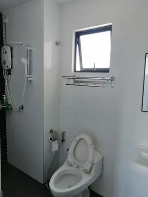 a white bathroom with a toilet and a window at The Horizon Ipoh Infinity Pool 5 to 9pax in Ipoh