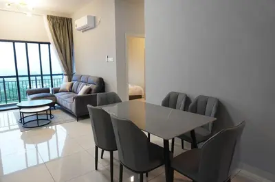 a living room with a table and chairs and a couch at The Horizon Ipoh Infinity Pool 5 to 9pax in Ipoh