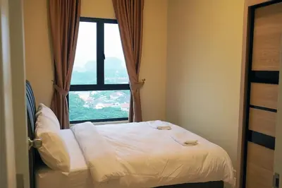 a bed in a room with a large window at The Horizon Ipoh Infinity Pool 5 to 9pax in Ipoh