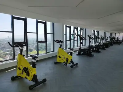 a gym with rows of exercise bikes in a room with windows at The Horizon Ipoh Infinity Pool 5 to 9pax in Ipoh