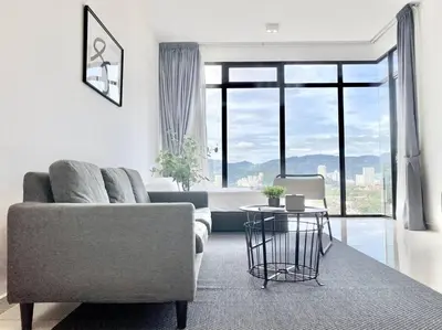 a living room with a couch and a table at Beacon Executive Suites #Minimalist #SkyPool #Georgetown #6pax #2BR 2bath #3 Queen #Quality well maintained #Private host in George Town