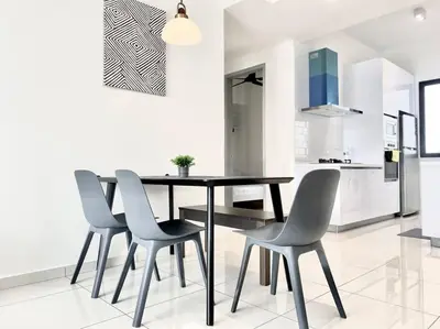 a dining room with a table and four chairs at Beacon Executive Suites #Minimalist #SkyPool #Georgetown #6pax #2BR 2bath #3 Queen #Quality well maintained #Private host in George Town