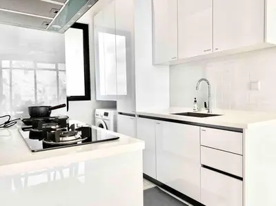 a white kitchen with a stove and a sink at Beacon Executive Suites #Minimalist #SkyPool #Georgetown #6pax #2BR 2bath #3 Queen #Quality well maintained #Private host in George Town