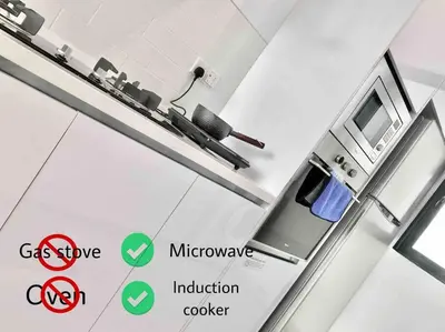a kitchen with a stove and a microwave in a room at Beacon Executive Suites #Minimalist #SkyPool #Georgetown #6pax #2BR 2bath #3 Queen #Quality well maintained #Private host in George Town