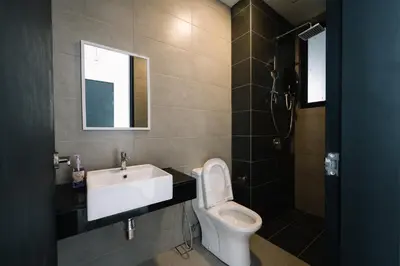 a bathroom with a toilet and a sink at NEW Infinity Pool 3 Bedrooms 2 Carparks 197 in Jelutong
