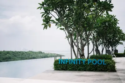 a sign that reads infinity pool next to a tree at NEW Infinity Pool 3 Bedrooms 2 Carparks 197 in Jelutong