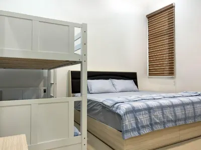 a bedroom with a bunk bed and a ladder at Taiping City View 3BR Condo near Lake Garden with Sunset View & Swimming Pool, Free Netflix WiFi in Taiping